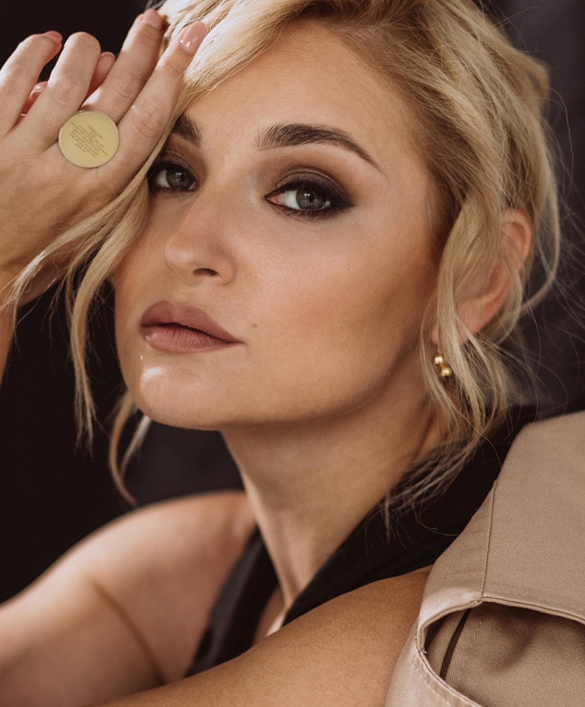 Woman with elegant makeup and styled hair.