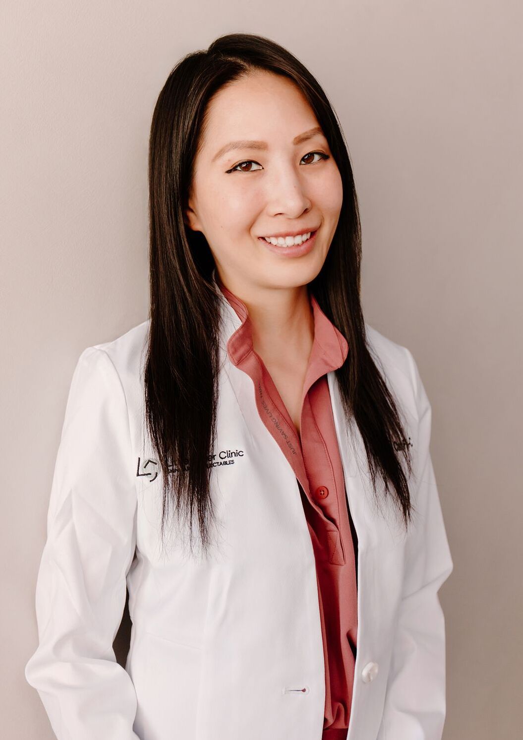little laser clinic founder Christine Chen, PA-C in a white coat smiling