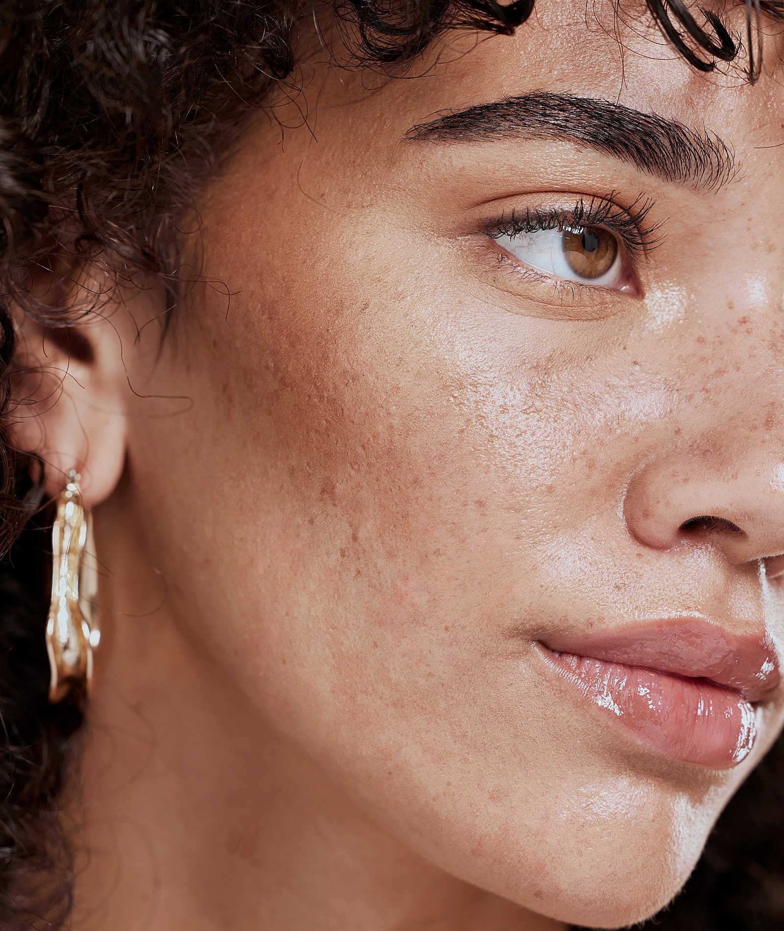 Close-up of a woman's face with earrings.