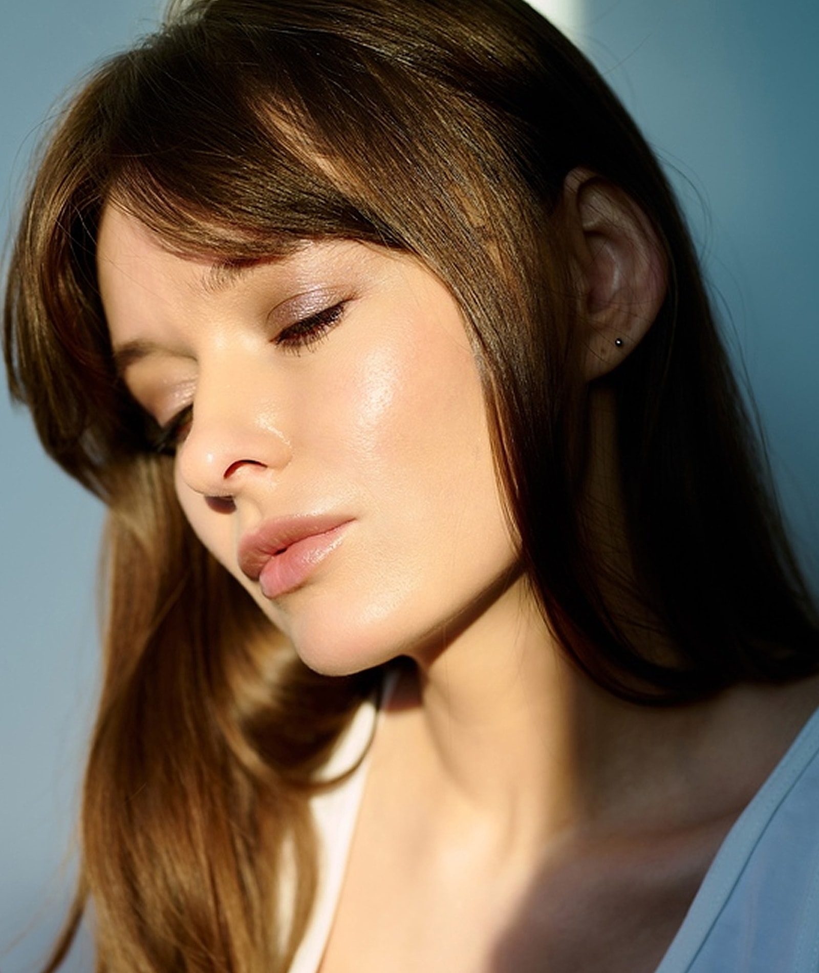 Woman with closed eyes and natural makeup.