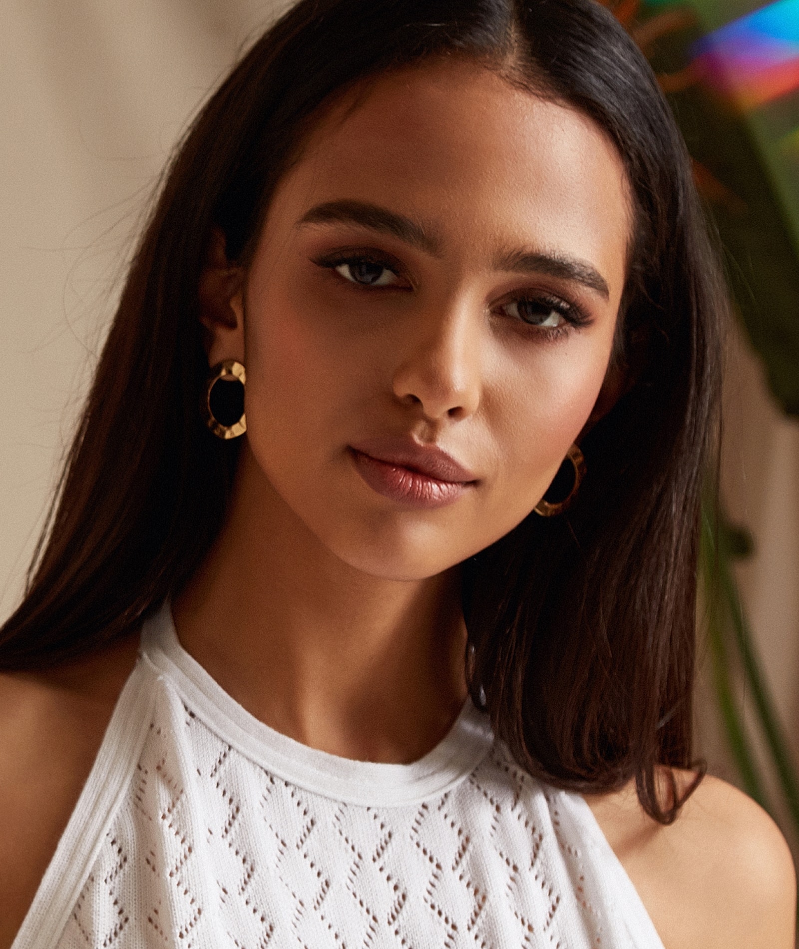 Woman with earrings and natural-looking makeup.
