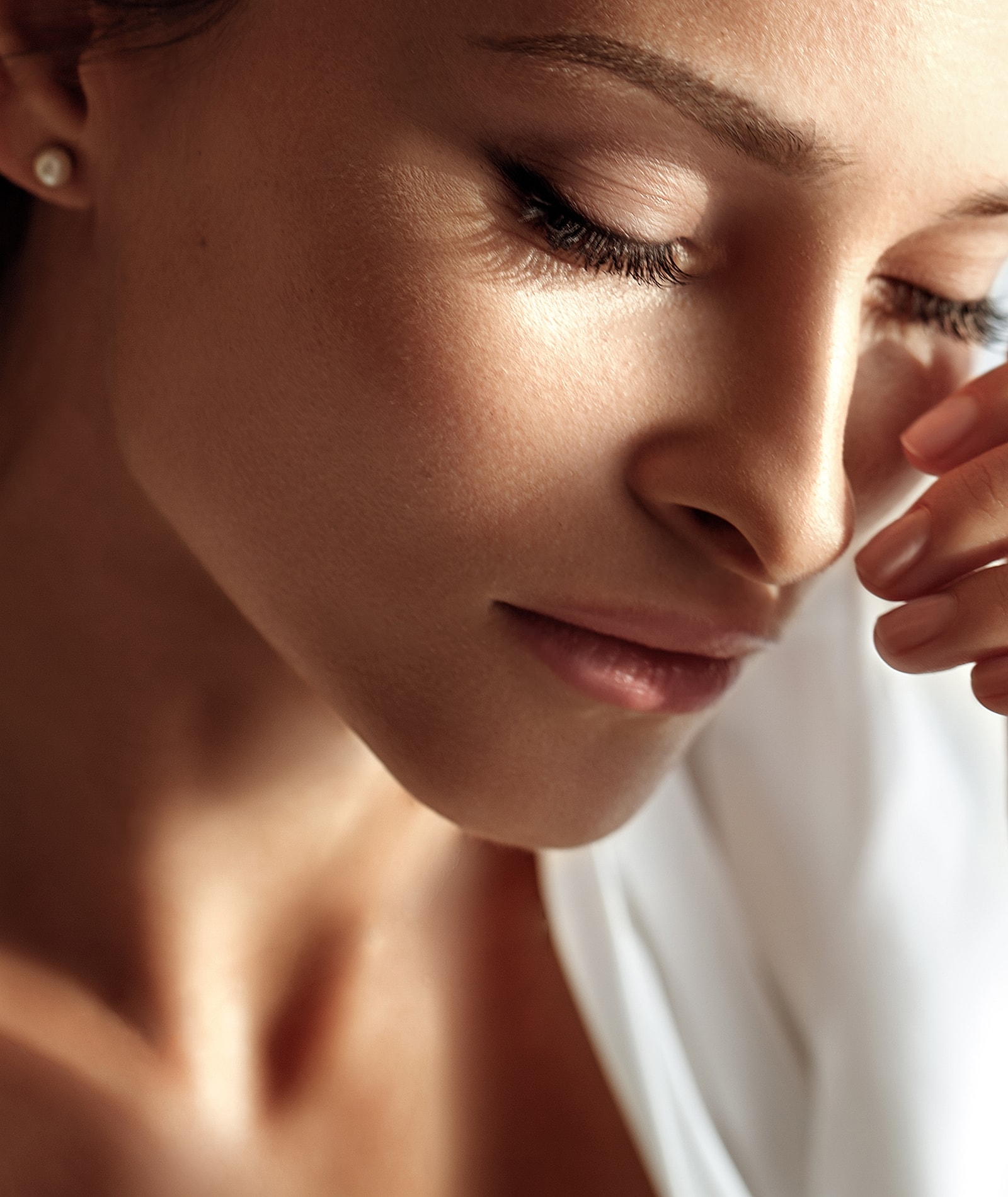 Close-up of a woman with soft expression.